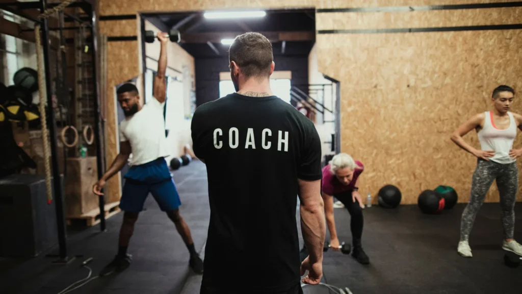 coach training people in the gym