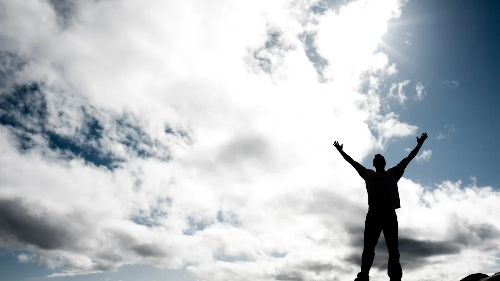 Man on top of the hill, being excited for winning